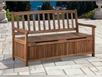 Brown wooden storage bench on a stone-paved terrace