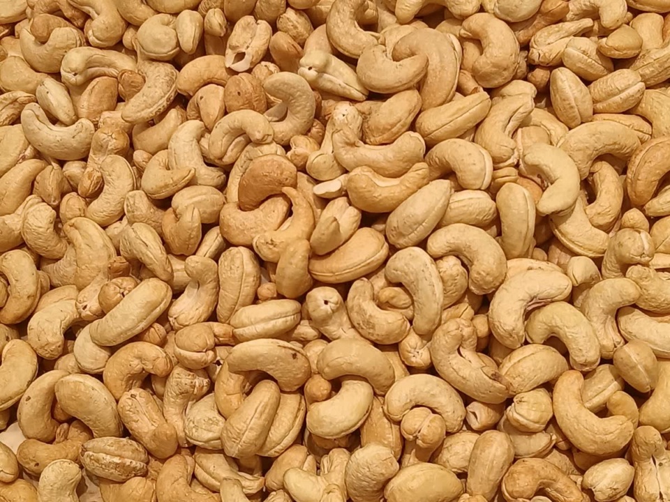 Golden brown charcoal roasted cashew kernels filling the frame