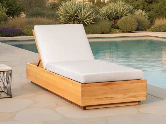 Box-framed wooden sun lounger with thick white cushion by a pool