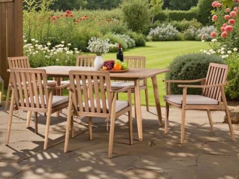 Acacia table and slat-back armchairs in a flower garden