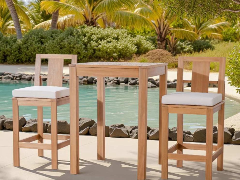 Square bar table and two cushioned bar stools beside a pool