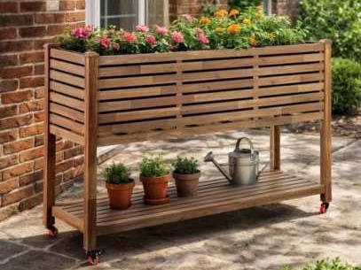 Raised wooden planter on wheels with a lower shelf of small pots