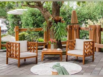 Two herringbone-slat armchairs and a square coffee table under trees