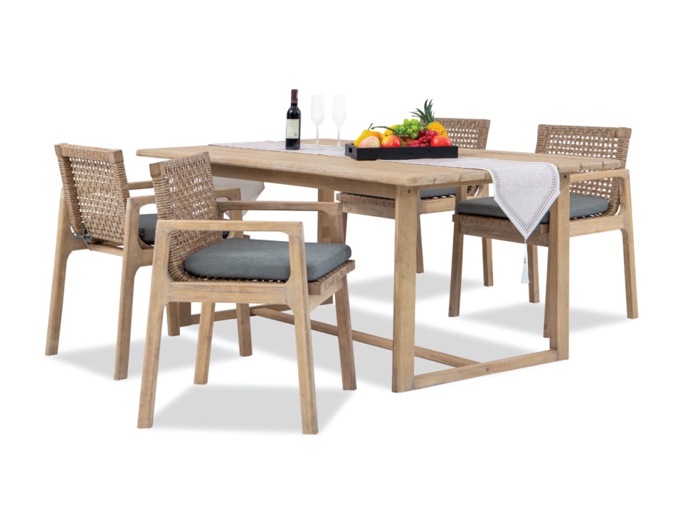 Wooden dining set with armchairs, woven backs and grey cushions, white background