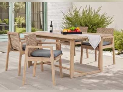 Acacia dining table and wicker-style chairs with charcoal cushions