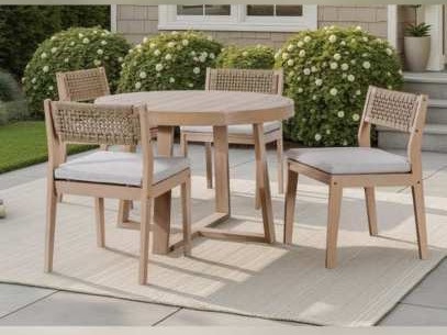 Round pedestal table and rope-back chairs on a patio rug