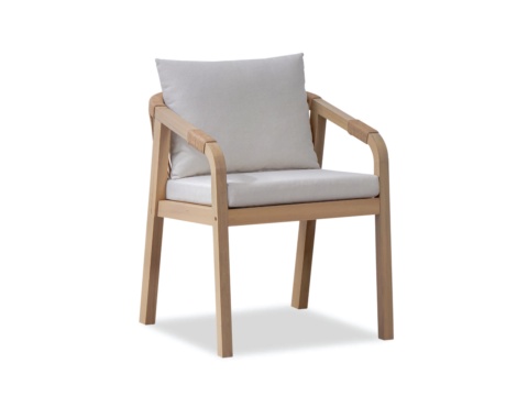 Dining armchair with curved wooden arms and light-coloured back and seat cushions