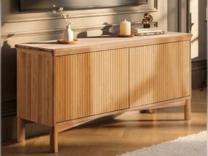 Light wooden sideboard with fluted double doors against a panelled wall