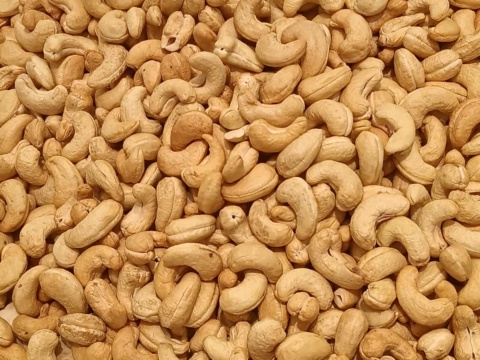 Golden brown charcoal roasted cashew kernels filling the frame