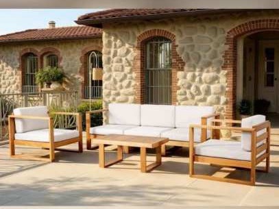 Sofa ba chỗ, hai ghế bành và bàn trà gỗ trước nhà đá