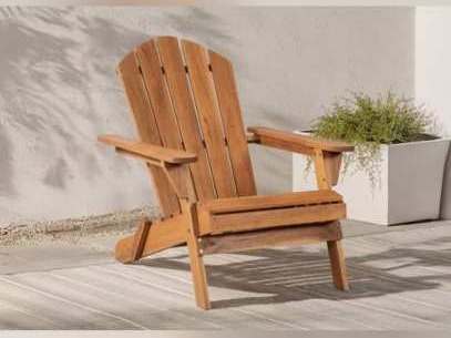 Wooden Adirondack chair with fan-shaped back beside a planter