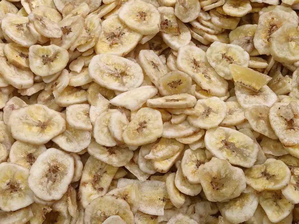 Cream coloured dried banana slices filling the frame