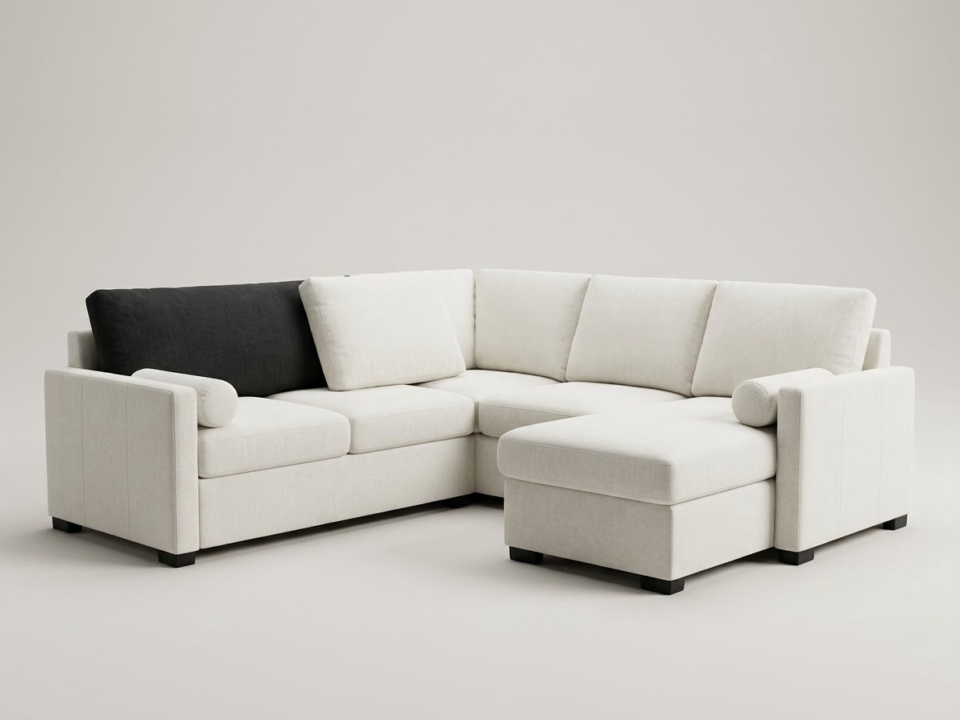 Off-white L-shaped corner sofa on a plain light backdrop